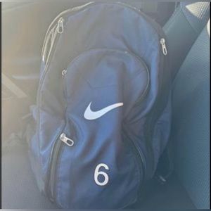 Blue Nike soccer bag with ball holder.